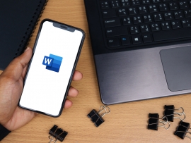 Microsoft Word app logo on smartphone screen, desk background - Chiang Mai, Thailand October 10, 2021