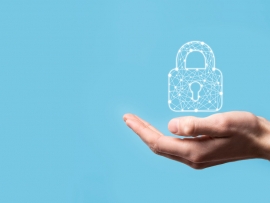 Hand holding a padlock representing business security.
