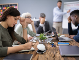 Discontent employees listening to a presentation.