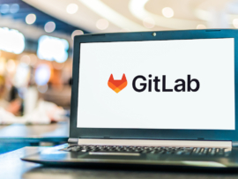 Laptop computer displaying logo of GitLab.